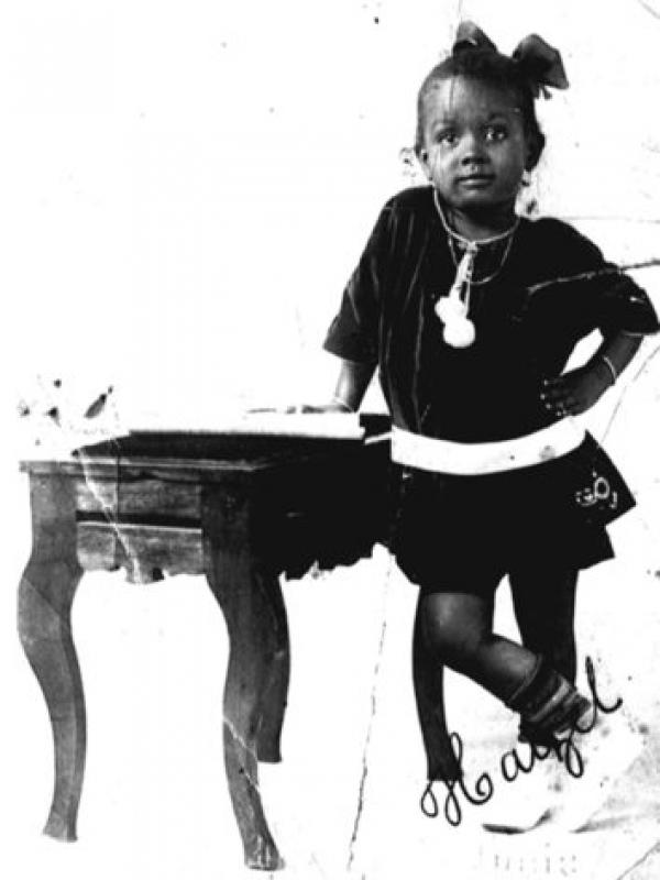Hazel Scott posing by a miniature piano